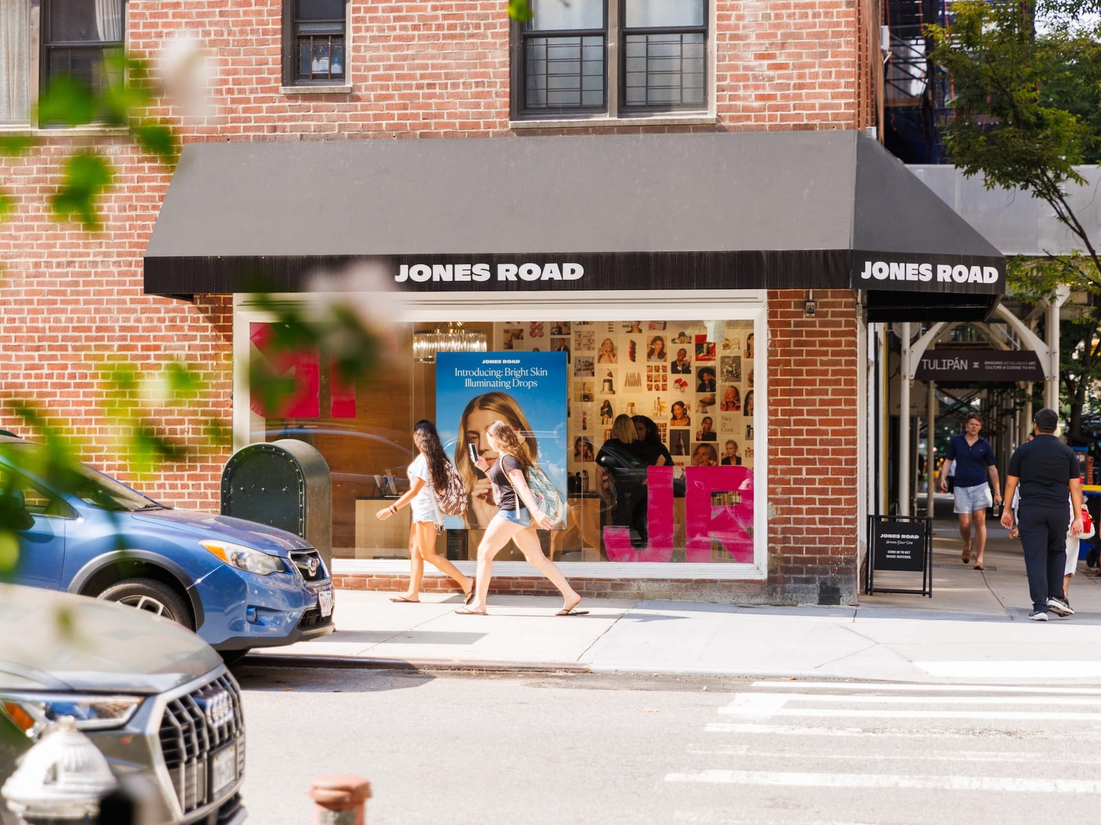 The Jones Road Beauty storefront on the Upper East Side, passers-by on the sidewalk